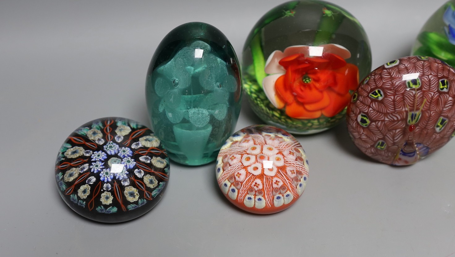 A collection of nine glass paperweights including Victorian dumps and millefiori